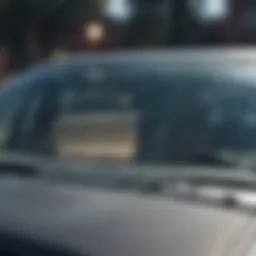 A close-up of a cracked windshield before replacement