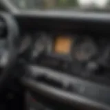 A close-up view of a car dashboard with the engine running and keys left inside.