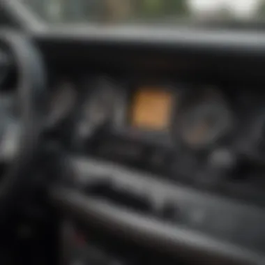 A close-up view of a car dashboard with the engine running and keys left inside.